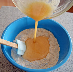 adding eggs to flour mixture for apple muffins