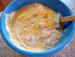 adding mashed banana to sifted flours