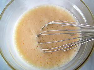 whisk together egg yolks, oil and milk