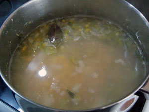 adding stock to chicken and corn soup