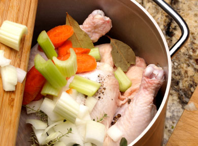 vegetables and chicken in pot ready to make stock