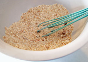 whisking sugar and coconut with flour for cake