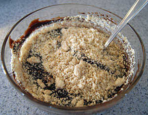 adding brown sugar and hazelnut meal to melted chocolate