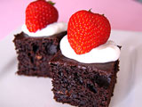 low fat brownies topped with yogurt and strawberries