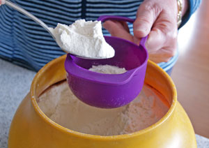 spooning flour into measuring cup