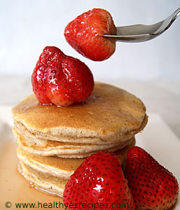 pancakes with strawberries and maple syrup