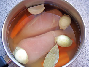 chicken poaching in a pot