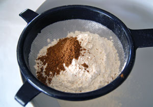 sifting flour for apricot nut bread