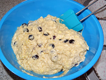 adding blueberries to muffin dough