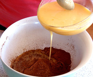 adding eggs to chocolate and flour