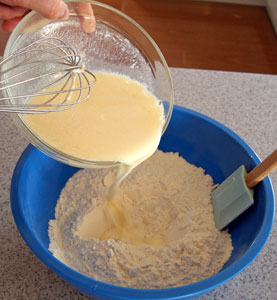 adding eggs to flour